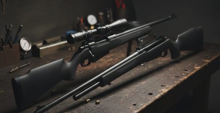 Two calibers of airgun pellets side by side on a dark surface.