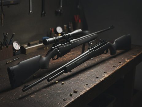Two calibers of airgun pellets side by side on a dark surface.